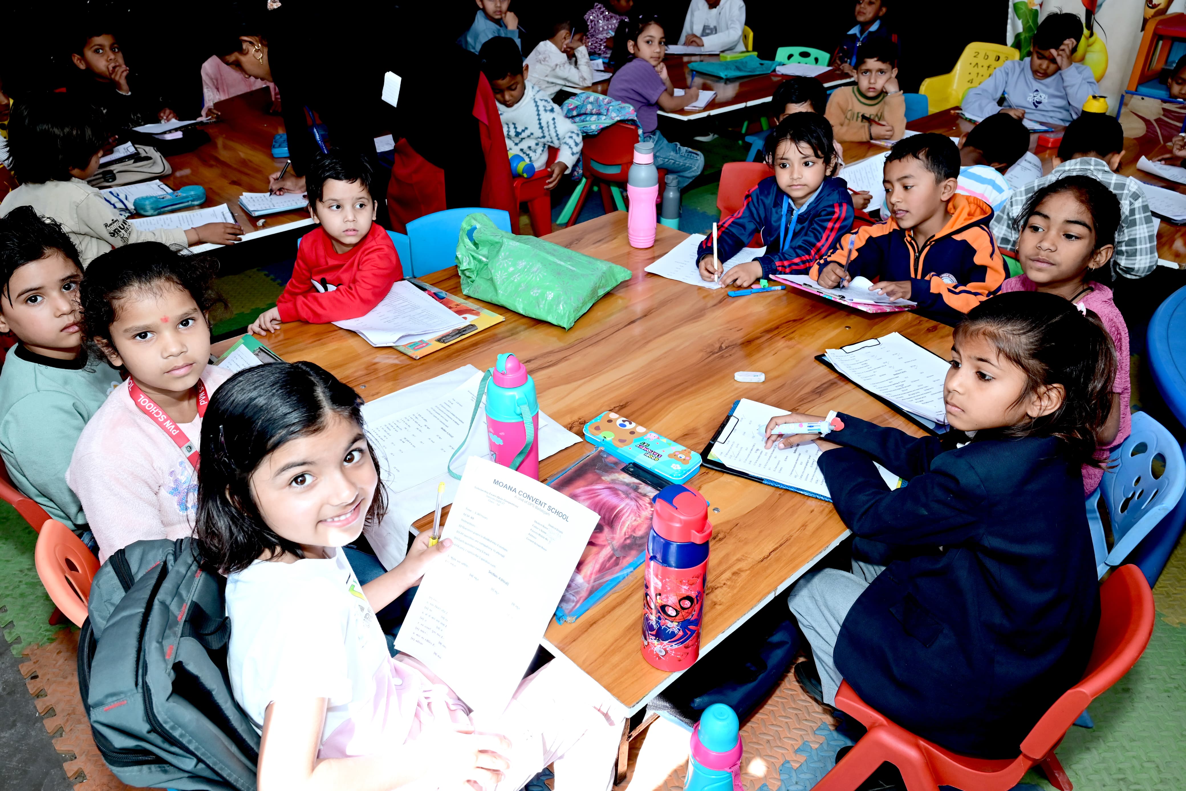 Young students writing quiz